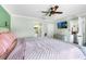 Bright main bedroom with ceiling fan, television, ensuite bathroom, and closet at 6178 Coliseum Blvd, Port Charlotte, FL 33981