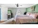 Comfortable main bedroom with a ceiling fan, ensuite bathroom, and large mirror at 6178 Coliseum Blvd, Port Charlotte, FL 33981
