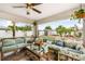 Relaxing patio with comfortable seating, fan, string lights, and view of the backyard at 6178 Coliseum Blvd, Port Charlotte, FL 33981