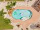 Overhead shot of a sparkling pool surrounded by a patio and tropical plants at 6178 Coliseum Blvd, Port Charlotte, FL 33981