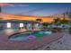 Beautiful backyard pool with waterfall feature, tropical landscaping, and brick paver surround at 6178 Coliseum Blvd, Port Charlotte, FL 33981