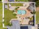Aerial view of backyard with a kidney-shaped pool with tropical landscaping, outdoor seating and white fence at 6178 Coliseum Blvd, Port Charlotte, FL 33981