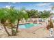 Backyard pool featuring a rock waterfall feature, barbecue area, and landscaped garden at 6178 Coliseum Blvd, Port Charlotte, FL 33981