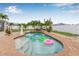 Inviting backyard pool with a rock waterfall feature, and landscaped garden at 6178 Coliseum Blvd, Port Charlotte, FL 33981