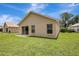 The property features a backyard with green grass, windows, sliding glass doors, and neighboring properties at 6352 Robin Cv, Lakewood Ranch, FL 34202