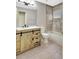 Charming bathroom features a rustic vanity with modern fixtures, complemented by decorative wall tile and a tub at 6352 Robin Cv, Lakewood Ranch, FL 34202