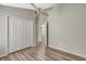 Bright bedroom offers ample closet space, wood-look flooring, and a ceiling fan for optimal comfort at 6352 Robin Cv, Lakewood Ranch, FL 34202