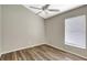 A sunny bedroom with wood-look floors features a ceiling fan and bright natural light from a large window at 6352 Robin Cv, Lakewood Ranch, FL 34202
