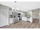 Beautiful kitchen features stainless steel appliances, white cabinets, modern flooring, and updated lighting at 6352 Robin Cv, Lakewood Ranch, FL 34202