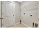 The laundry room features tile flooring, a storage shelf, and utility connections for appliances at 6352 Robin Cv, Lakewood Ranch, FL 34202