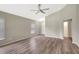 Well-lit living room featuring modern flooring, neutral walls, a ceiling fan, and views of other rooms at 6352 Robin Cv, Lakewood Ranch, FL 34202
