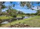 Scenic pond view with lush greenery provides a tranquil backdrop, complemented by the natural beauty of the surroundings at 6352 Robin Cv, Lakewood Ranch, FL 34202