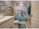 Bright bathroom featuring a sea turtle shower curtain and white vanity at 640 Encarnacion St, Punta Gorda, FL 33983