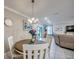Cozy dining area with wood table, seating for four, and a decorative chandelier at 640 Encarnacion St, Punta Gorda, FL 33983