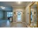 Inviting home entry featuring decorative mirrors, chandelier lighting, and neutral tile flooring at 640 Encarnacion St, Punta Gorda, FL 33983