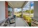 Inviting front porch featuring decorative stone accents and a comfortable seating area with seasonal flowers at 640 Encarnacion St, Punta Gorda, FL 33983