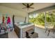 Well-appointed sunroom with a luxurious hot tub, ceiling fan, and access to the outdoors at 640 Encarnacion St, Punta Gorda, FL 33983