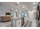 Open-concept kitchen with granite island and stainless steel appliances overlooking living area at 640 Encarnacion St, Punta Gorda, FL 33983