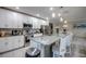 Modern kitchen features white cabinets, stainless steel appliances, and a spacious granite island with bar seating at 640 Encarnacion St, Punta Gorda, FL 33983