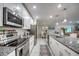 Bright open kitchen with granite counters, tile floor and stainless steel appliances at 640 Encarnacion St, Punta Gorda, FL 33983