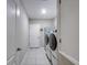 Neat laundry room featuring a white door and modern appliances, offering convenience and functionality at 640 Encarnacion St, Punta Gorda, FL 33983