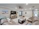 Comfortable living room boasts modern decor, a large TV, and plenty of natural light from the nearby windows at 640 Encarnacion St, Punta Gorda, FL 33983