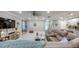 Inviting living room with stylish furnishings, a large TV, and seamless access to the kitchen and entryway at 640 Encarnacion St, Punta Gorda, FL 33983
