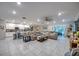 Large living room featuring tile floors, an open layout connecting kitchen and dining, and stylish modern decor at 640 Encarnacion St, Punta Gorda, FL 33983