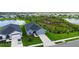 Beautiful aerial view of a home with a well-manicured lawn and pond at 6435 165Th E Dr, Parrish, FL 34219