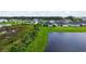 Aerial view of a community pond and several homes at 6435 165Th E Dr, Parrish, FL 34219