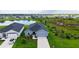 Beautiful aerial view of a home with a well-manicured lawn and pond at 6435 165Th E Dr, Parrish, FL 34219