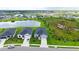 Scenic aerial shot showcases neighborhood homes, tranquil ponds, and verdant landscaping at 6435 165Th E Dr, Parrish, FL 34219