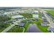An aerial view of a suburban neighborhood featuring modern homes and scenic ponds at 6435 165Th E Dr, Parrish, FL 34219