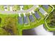 Overhead aerial view of three homes on a pond showing their rooflines at 6435 165Th E Dr, Parrish, FL 34219