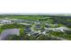 An aerial view shows a suburban neighborhood featuring modern homes surrounded by picturesque ponds at 6435 165Th E Dr, Parrish, FL 34219