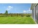 Expansive backyard with a view of neighboring homes, merging community living with tranquil nature at 6435 165Th E Dr, Parrish, FL 34219