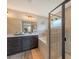 Well-lit bathroom with a double sink vanity, bathtub and glass shower with neutral tile at 6435 165Th E Dr, Parrish, FL 34219