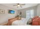 Comfortable bedroom showcasing a ceiling fan, wooden bed, and a wall-mounted TV at 6435 165Th E Dr, Parrish, FL 34219