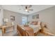 Cozy bedroom featuring a wooden bed frame, ceiling fan, and natural light at 6435 165Th E Dr, Parrish, FL 34219