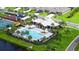 A sparkling community pool surrounded by lush landscaping and swaying palm trees at 6435 165Th E Dr, Parrish, FL 34219
