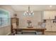 Dining area with modern lighting, a table with seating, and a charming cabinet at 6435 165Th E Dr, Parrish, FL 34219