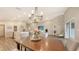 Bright dining room features stylish chandelier, an inviting atmosphere, and seamless access to living areas at 6435 165Th E Dr, Parrish, FL 34219