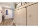 Inviting entryway featuring modern wood-look floors, board and batten accent wall, and a conveniently placed coat rack at 6435 165Th E Dr, Parrish, FL 34219