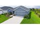 Charming single Gathering home featuring a two-car garage and a beautifully landscaped front yard at 6435 165Th E Dr, Parrish, FL 34219