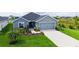 Charming single Gathering home featuring a two-car garage and a beautifully landscaped front yard at 6435 165Th E Dr, Parrish, FL 34219