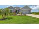 Charming single Gathering home featuring a two-car garage and a beautifully landscaped front yard at 6435 165Th E Dr, Parrish, FL 34219
