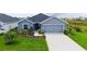 Charming single Gathering home featuring a two-car garage and a beautifully landscaped front yard at 6435 165Th E Dr, Parrish, FL 34219