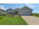 Charming single Gathering home featuring a two-car garage and a beautifully landscaped front yard at 6435 165Th E Dr, Parrish, FL 34219
