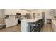 Modern kitchen featuring white cabinets, stainless steel appliances, and a spacious center island with seating at 6435 165Th E Dr, Parrish, FL 34219