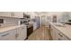 Modern kitchen with stainless steel appliances, white cabinetry, and sleek countertops at 6435 165Th E Dr, Parrish, FL 34219